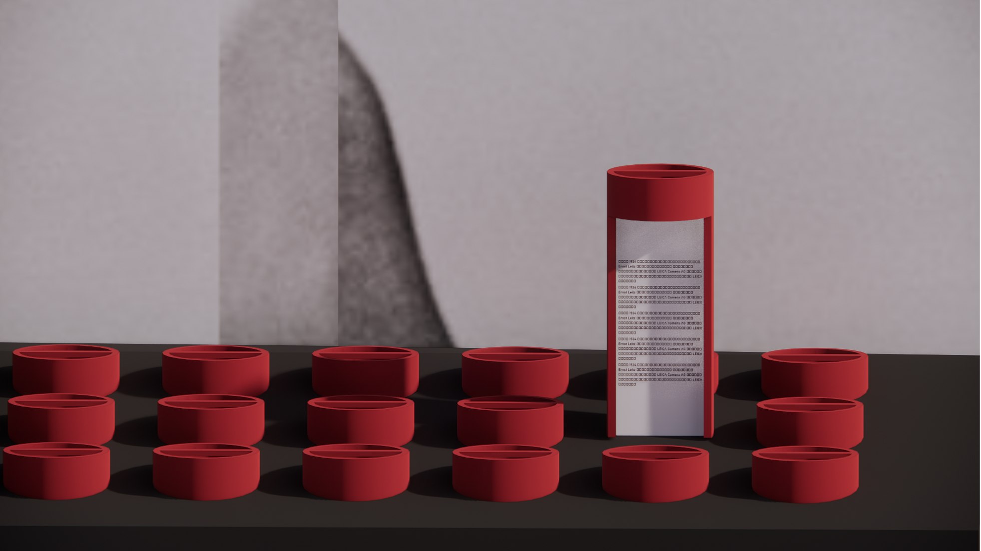Grid of red lens caps beside a red cylindrical reader
