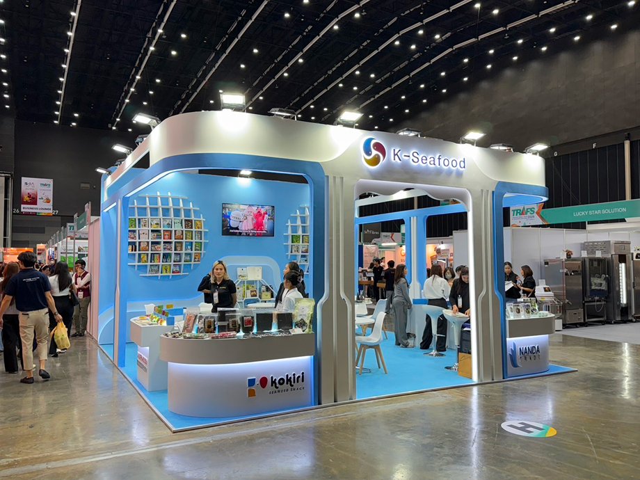 The booth from the opposite corner with staff at the counters